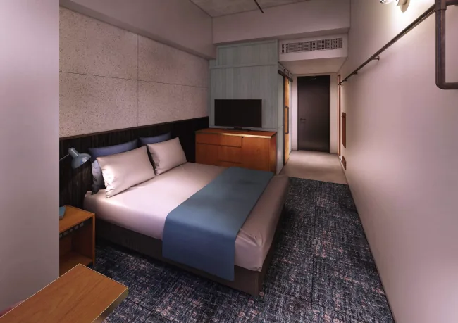 ห้องพักสำหรับสองท่านของ The HOTEL Well-hub Haneda มีเตียงคู่ โต๊ะเขียนหนังสือ และเก้าอี้